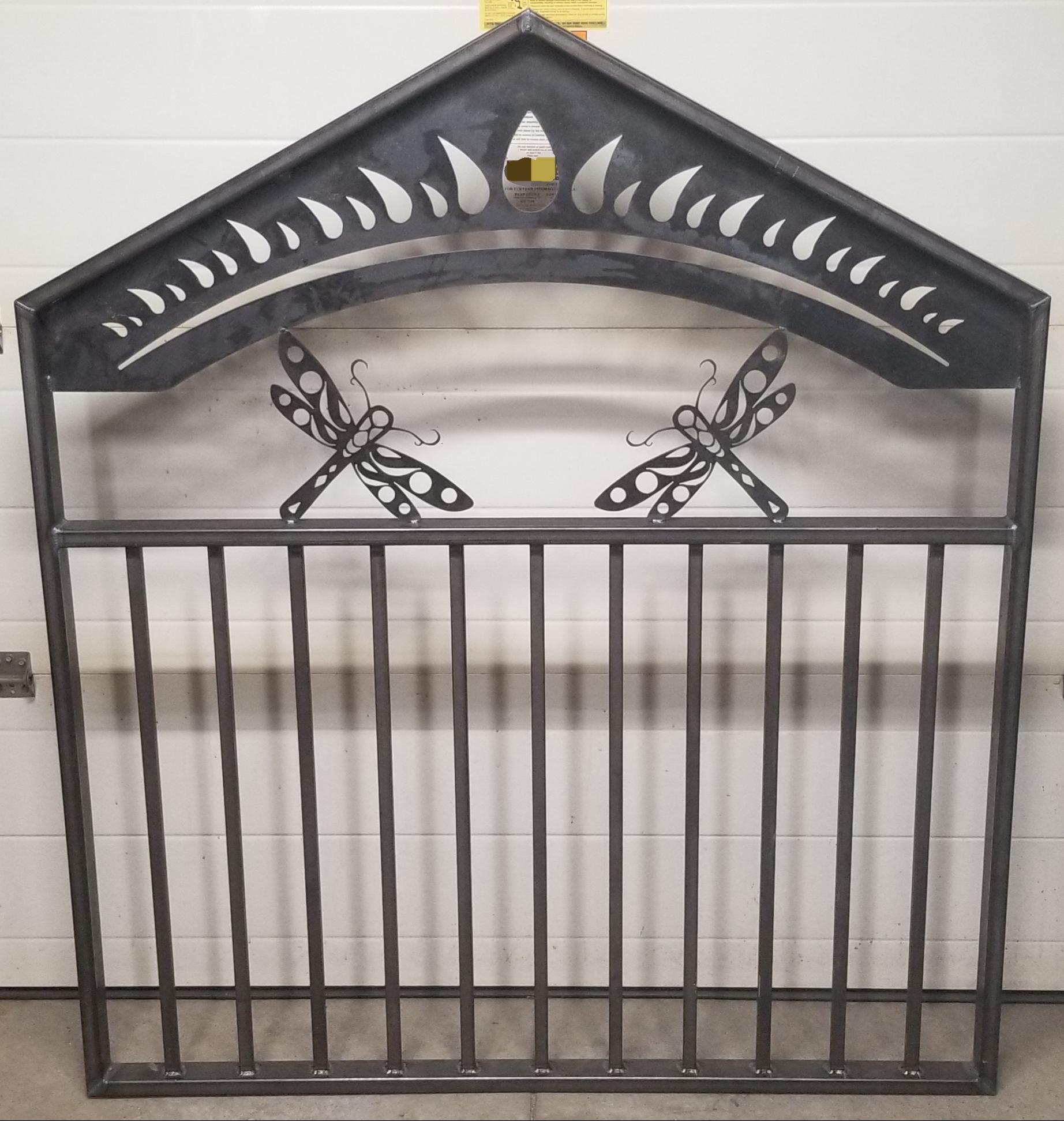 Ornate gate with dragonfly design